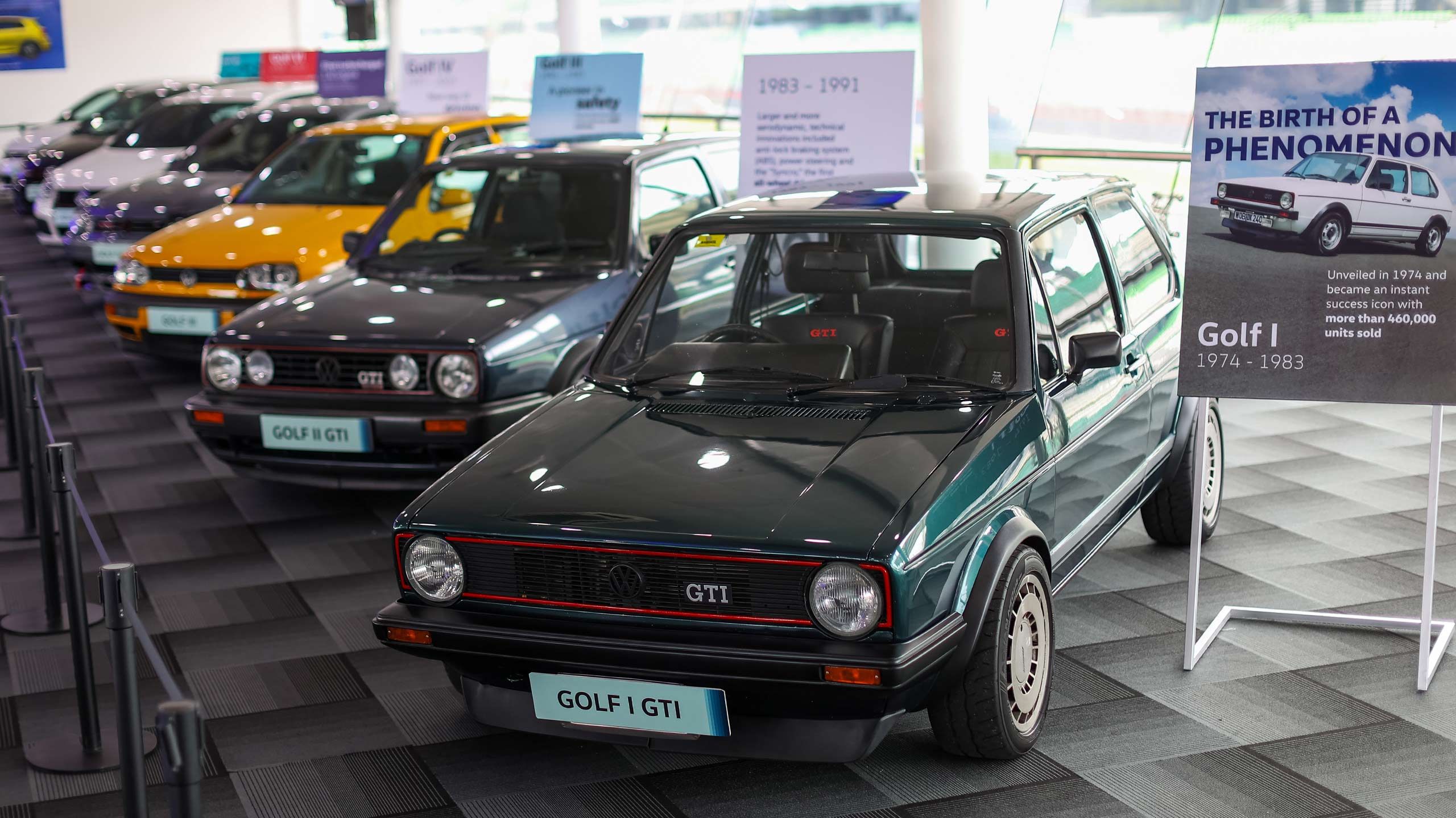 A row of vintage Volkswagen Golf GTI models on display.